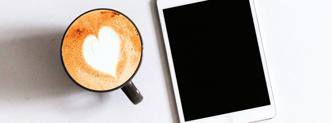 A black-screen iPad with a cup of coffee