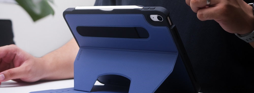 a person holding a blue ipad case on a table