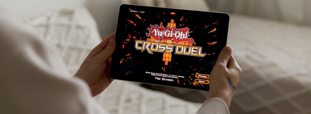 a person holding a tablet with a video game on it
