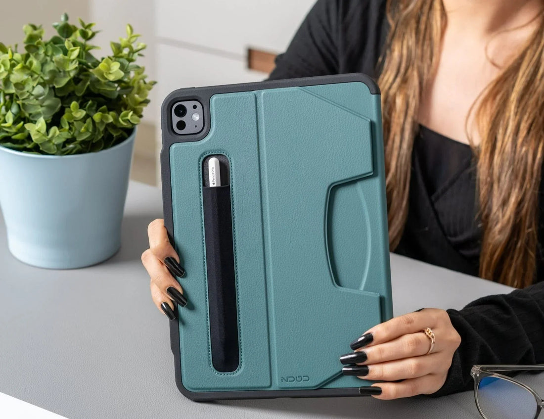 Woman holding a teal ZUGU protective iPad case with Apple Pencil storage 